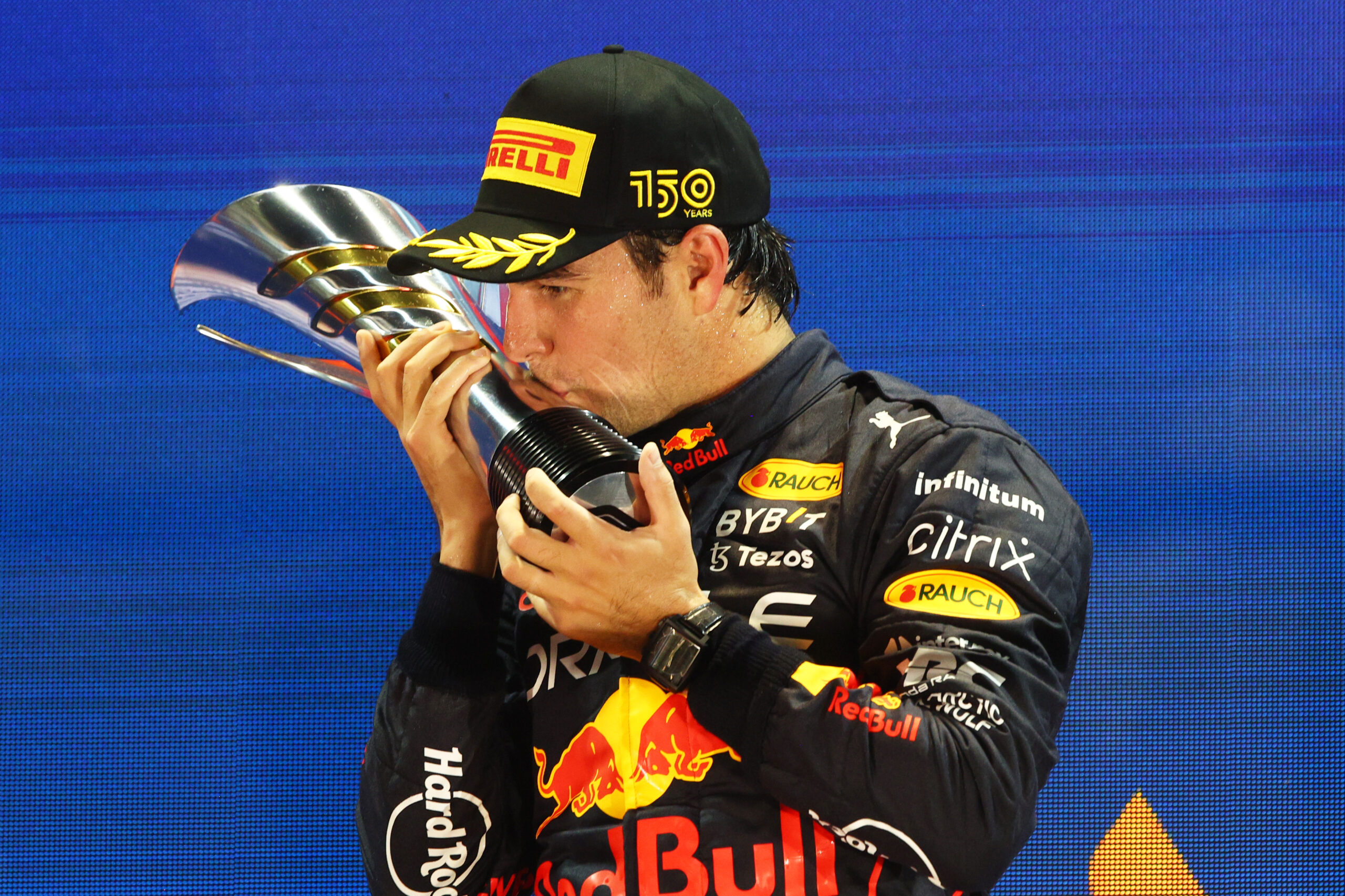 SINGAPORE, SINGAPORE – OCTOBER 02: Race winner Sergio Perez of Mexico and Oracle Red Bull Racing celebrates on the podium during the F1 Grand Prix of Singapore at Marina Bay Street Circuit on October 02, 2022 in Singapore, Singapore. (Photo by Clive Rose/Getty Images,) // Getty Images / Red Bull Content Pool // SI202210020445 // Usage for editorial use only //